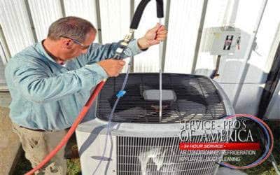 technician cleaning ac coil 